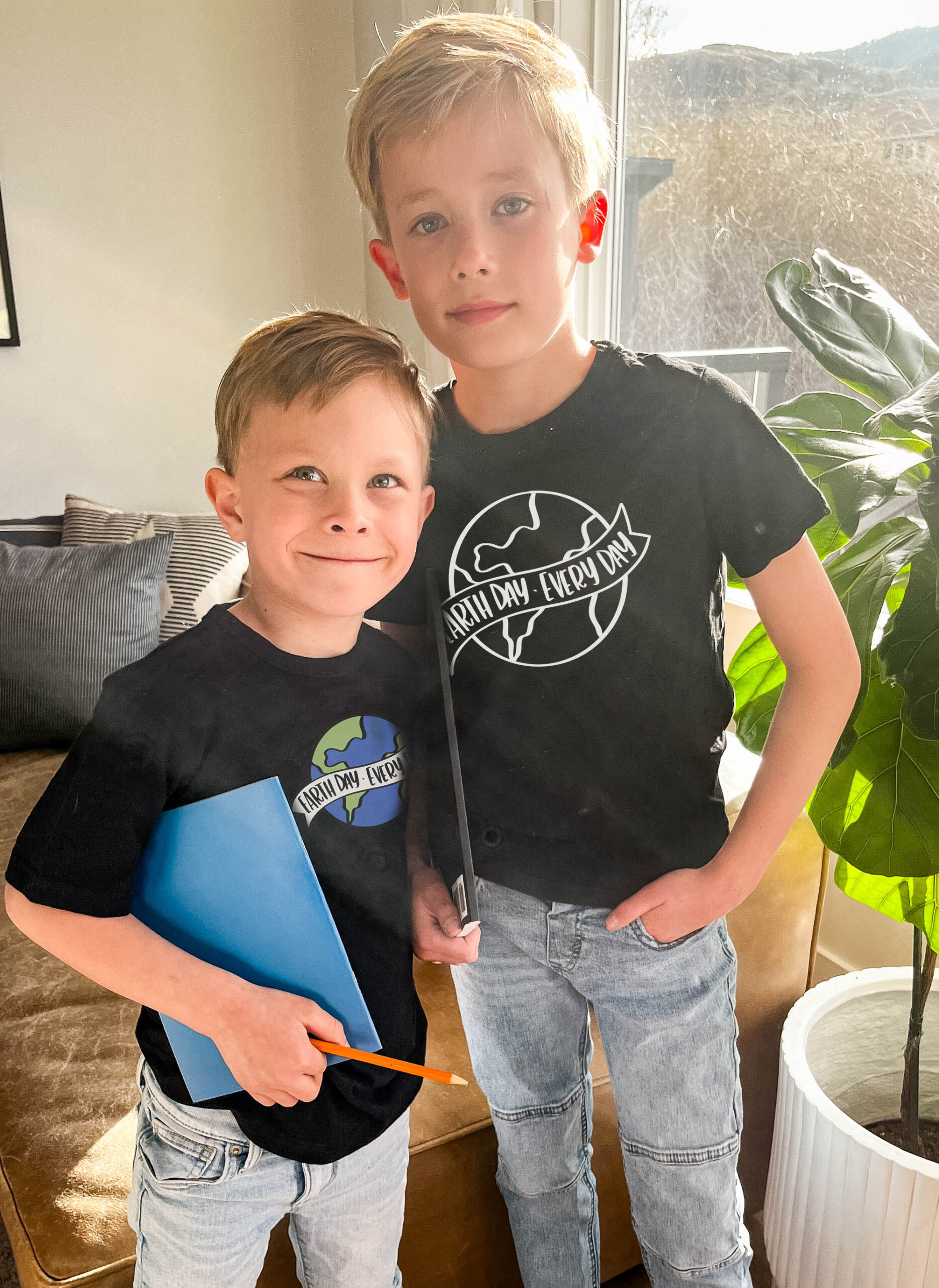 boys wearing black tee shirts with vinyl transfer. hand lettered 'earth day every day' design. text over reads 'free svg for earth day'