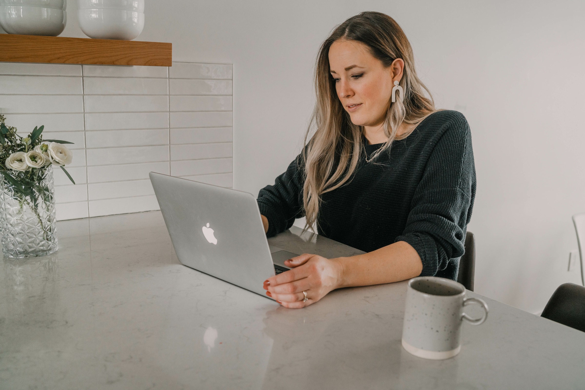 girl planning a room makeover at a computer with coffee