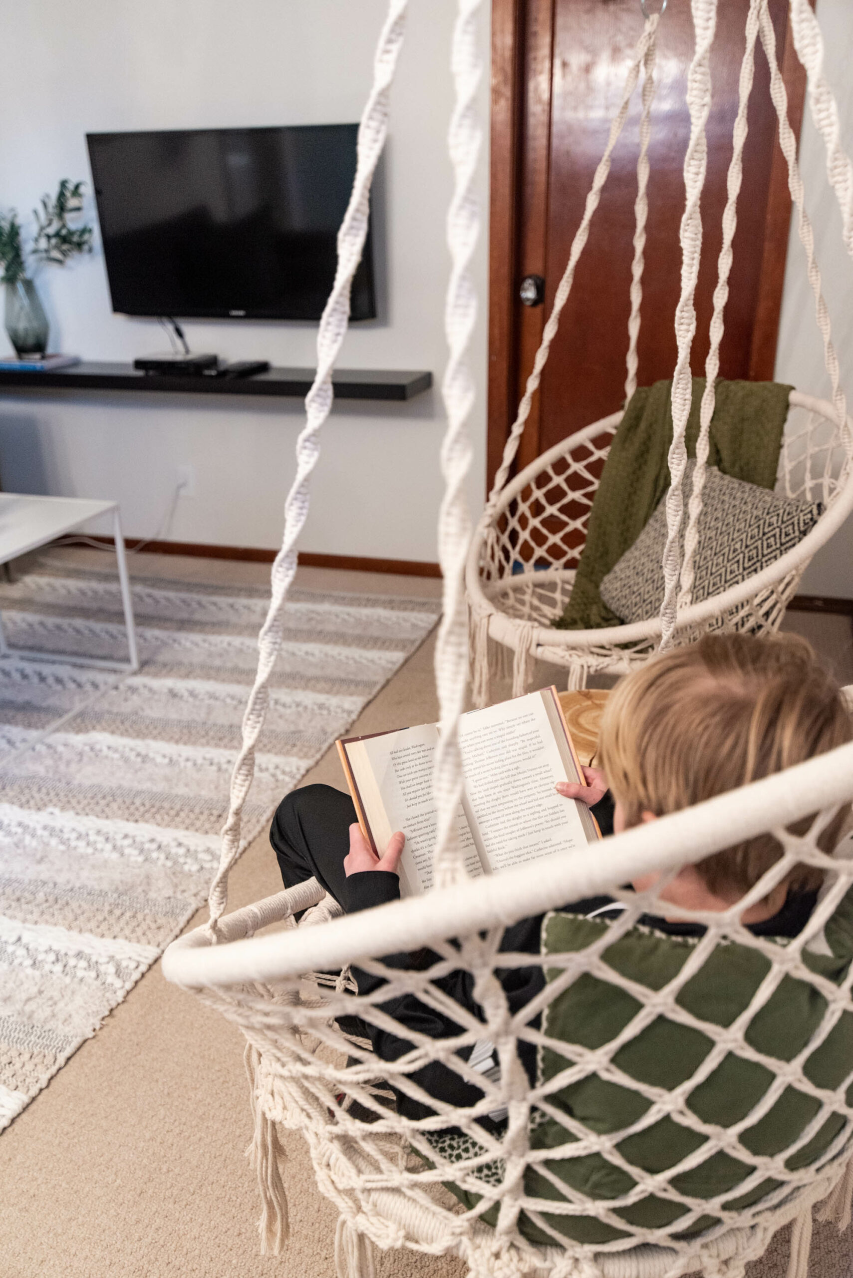 Cozy reading spot in an airbnb- macrame hanging chairs
