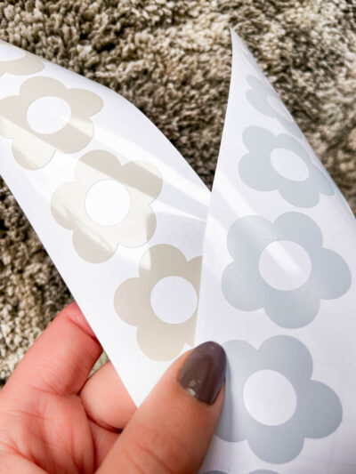 What is the best vinyl to use for my decals? a comparison- image of two sheets of flower decals, one in clay glossy permanent adhesive vinyl, one in light blue matte removable adhesive vinyl