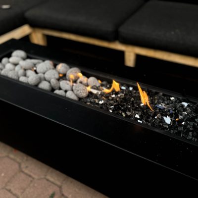 long rectangle fire table with lava pebbles and reflective black fire glass for a fire table media comparison