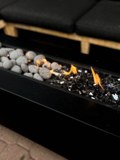 long rectangle fire table with lava pebbles and reflective black fire glass for a fire table media comparison