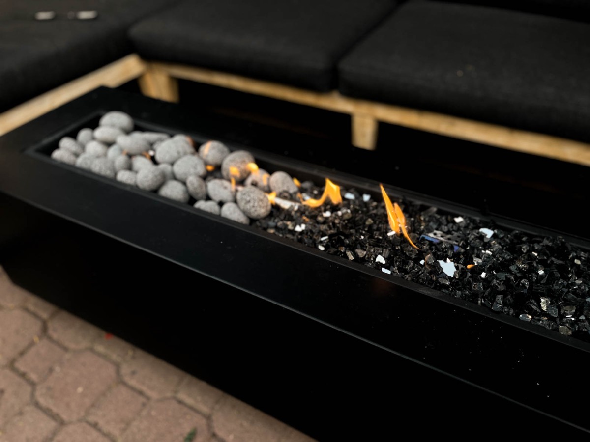 long rectangle fire table with lava pebbles and reflective black fire glass for a fire table media comparison