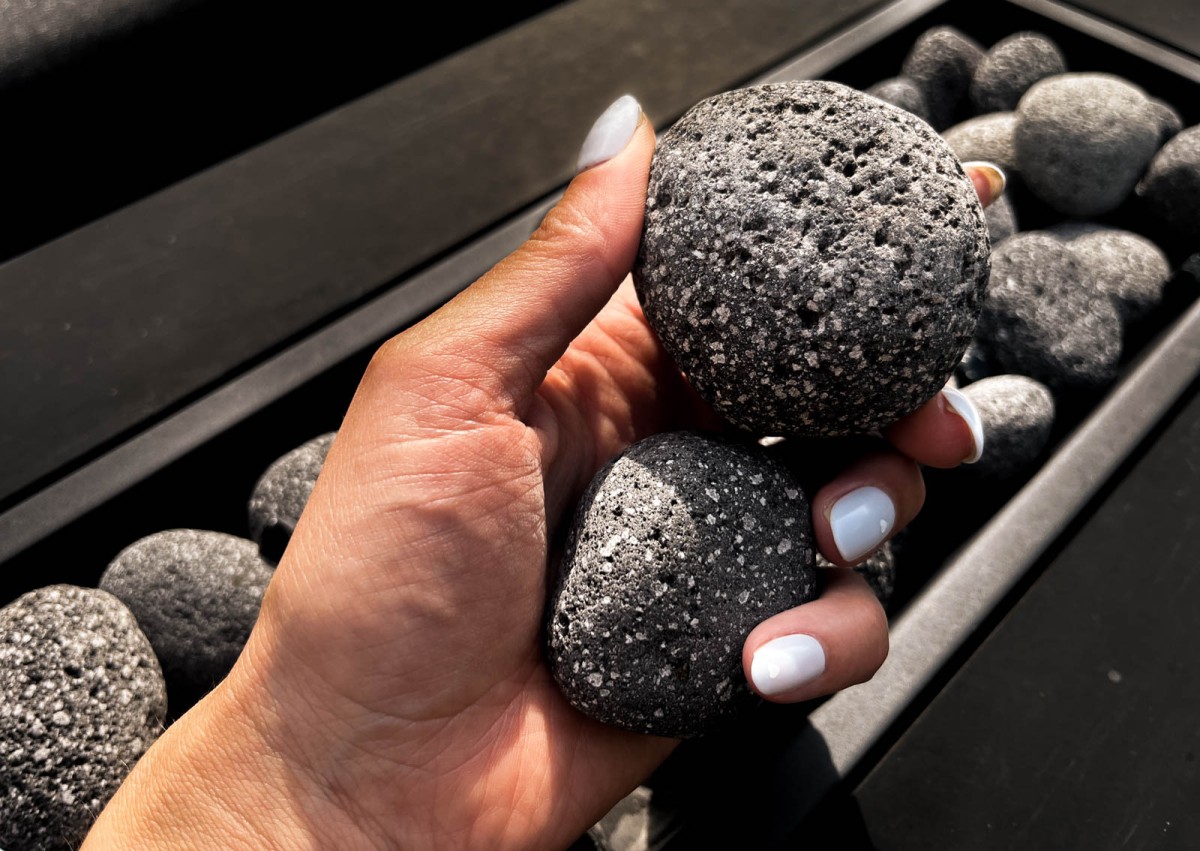 holding lava pebbles in grey