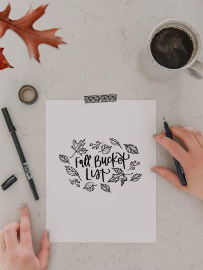 Free Printable Fall bucket lists with ideas (image of printed bucket list template and hands ready to fill in the list