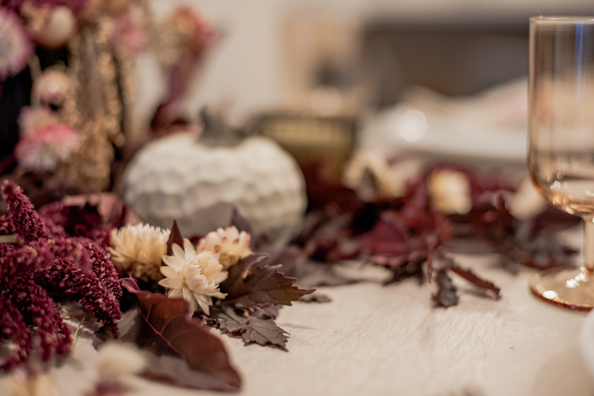 Organic Fall Tablescape full of straw flowers and mahogany splendor