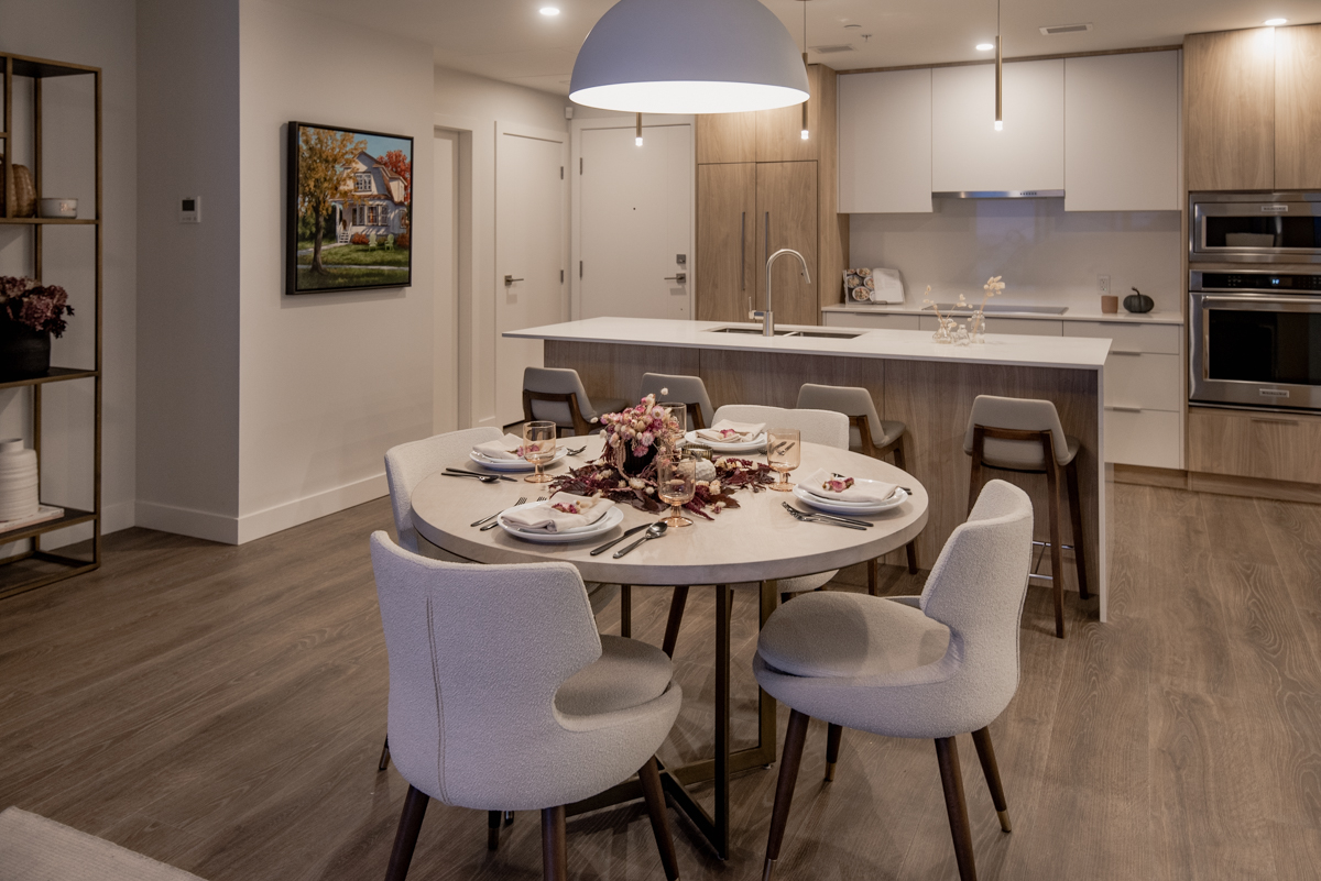 Organic fall tablescape with deep red foliage on a round table in a modern apartment