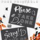 Free printable halloween candy signs, image of signs on a countertop with halloween candy. signs read: please take one and sorry out of candy