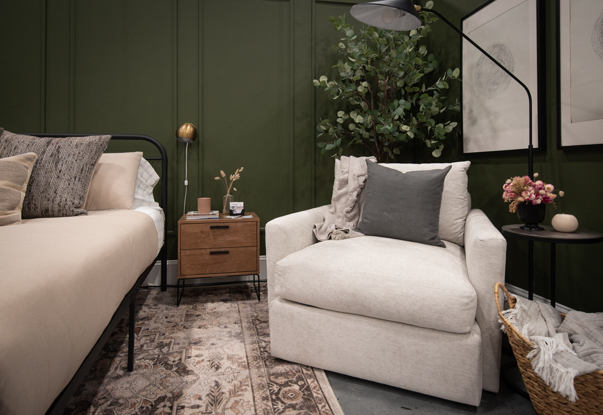 Cozy reading area in a green bedroom design