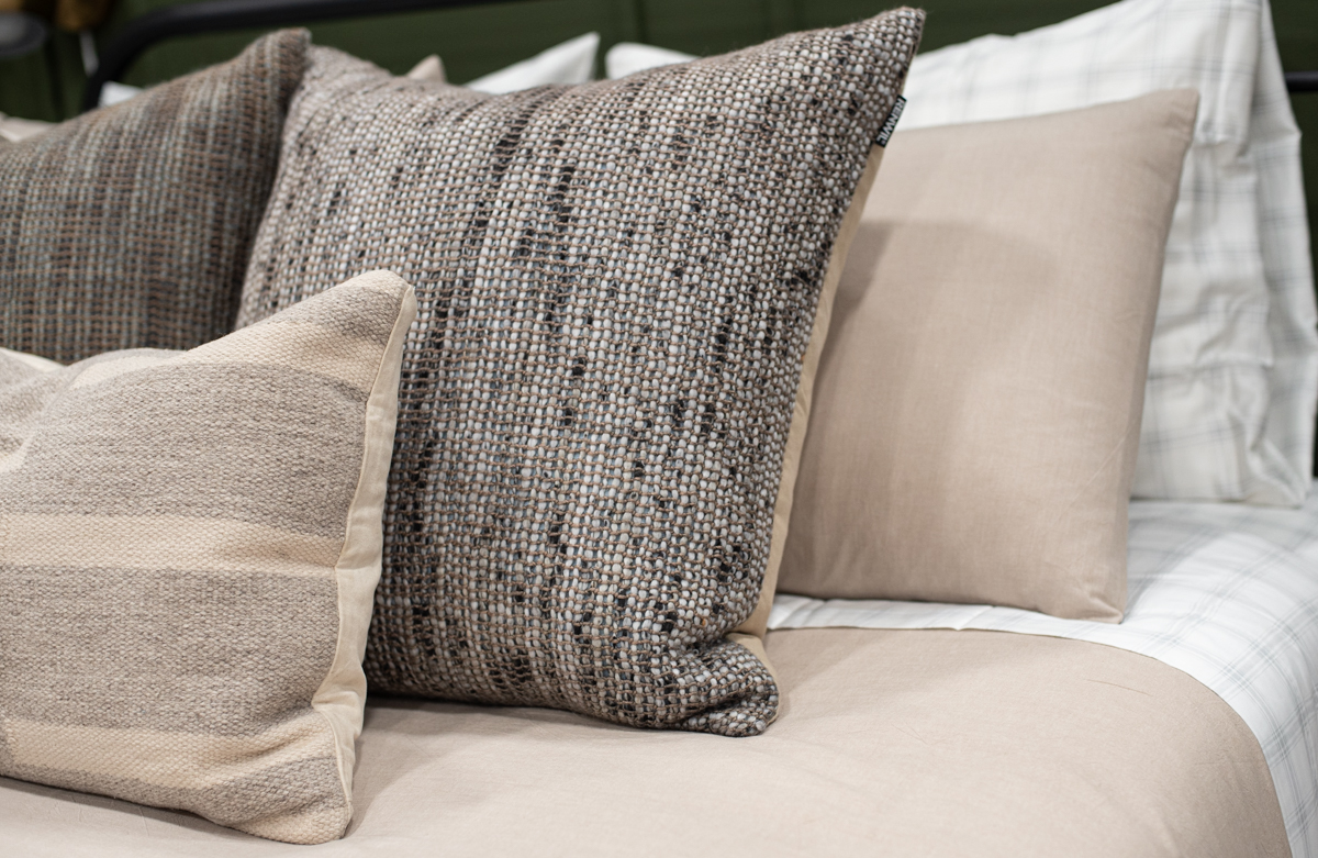 textured pillows in a dark and moody bedroom