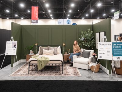 Dark green bedroom feature with picture frame moulding wall at the calgary home show