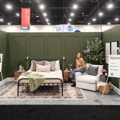 Dark green bedroom feature with picture frame moulding wall at the calgary home show