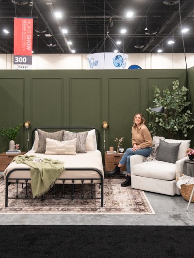 Dark green bedroom feature with picture frame moulding wall at the calgary home show