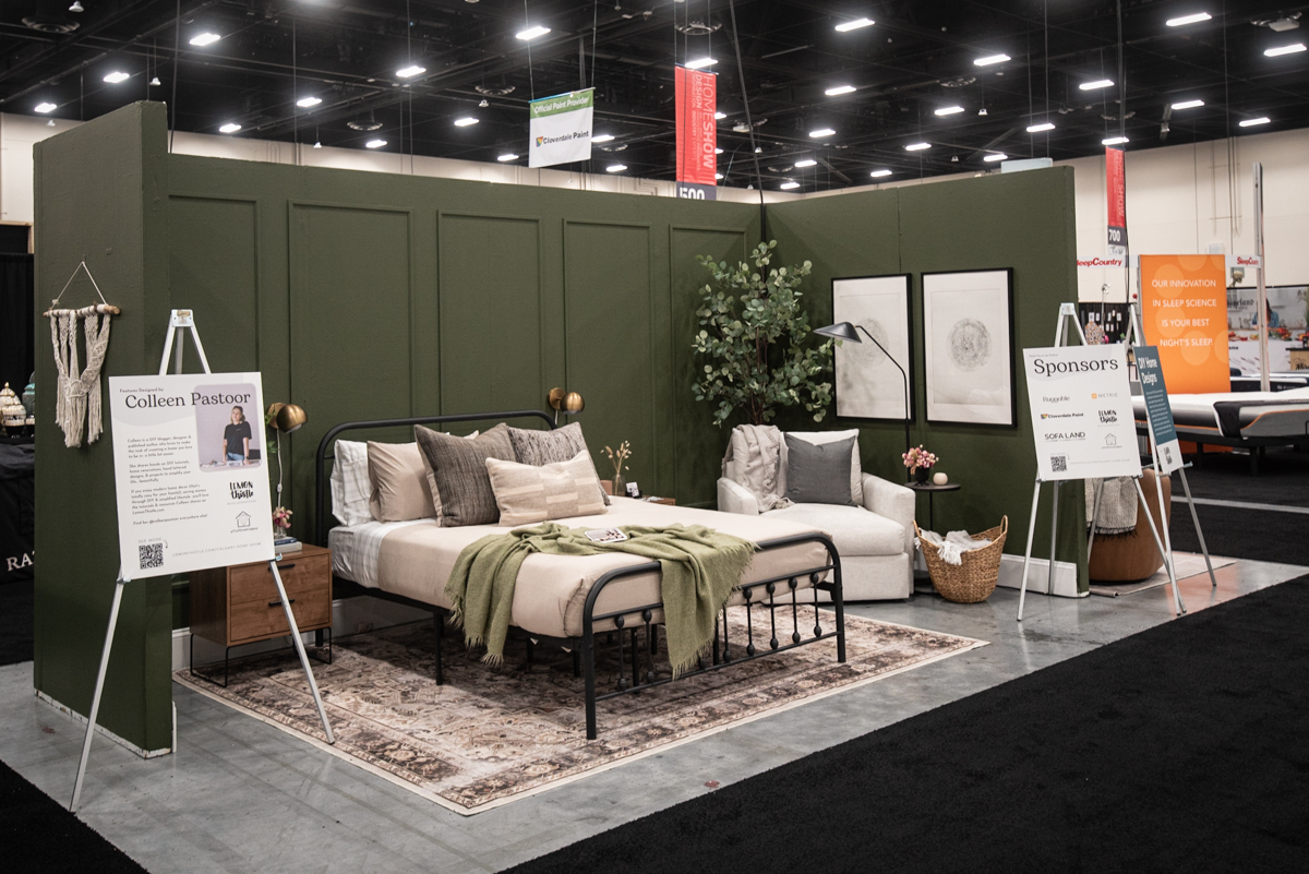 Dark green bedroom feature with picture frame moulding wall at the calgary home show