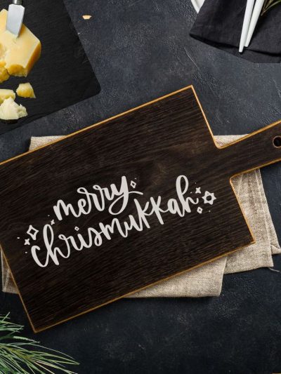 Free Chrismukkah SVG file shown on wooden serving board