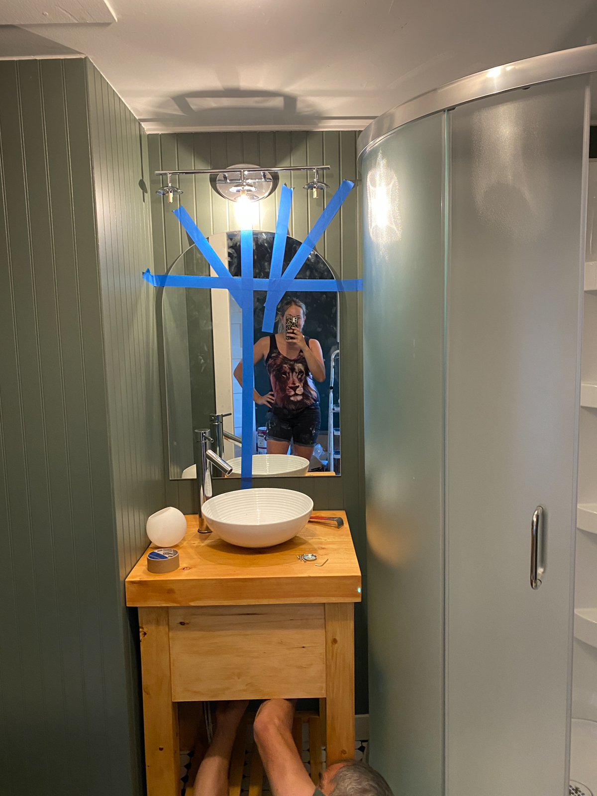 DIY bathroom makeover including a custom cut arch mirror for an affordable upgrade