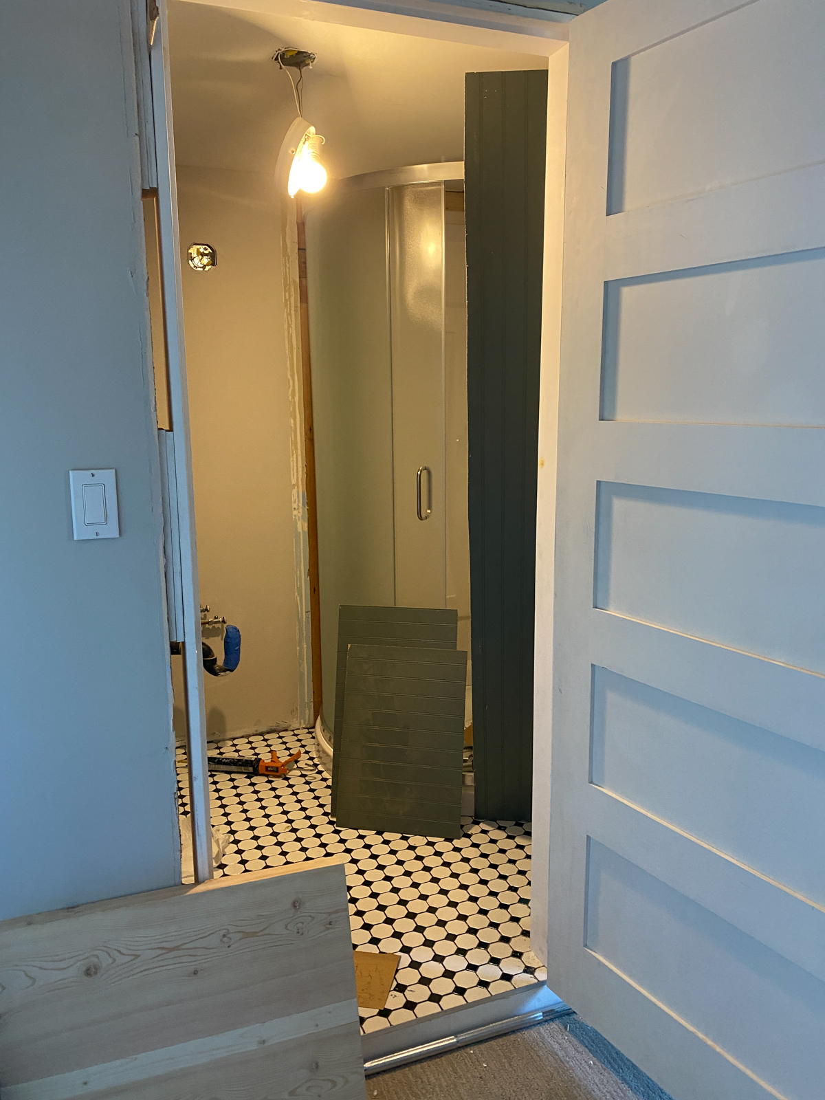 DIY Bathroom Remodel progress photo with flooring and shower installed
