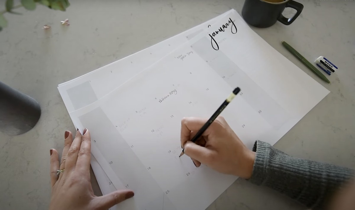 oversized calendar for family calendar planning- free printable calendar being written on