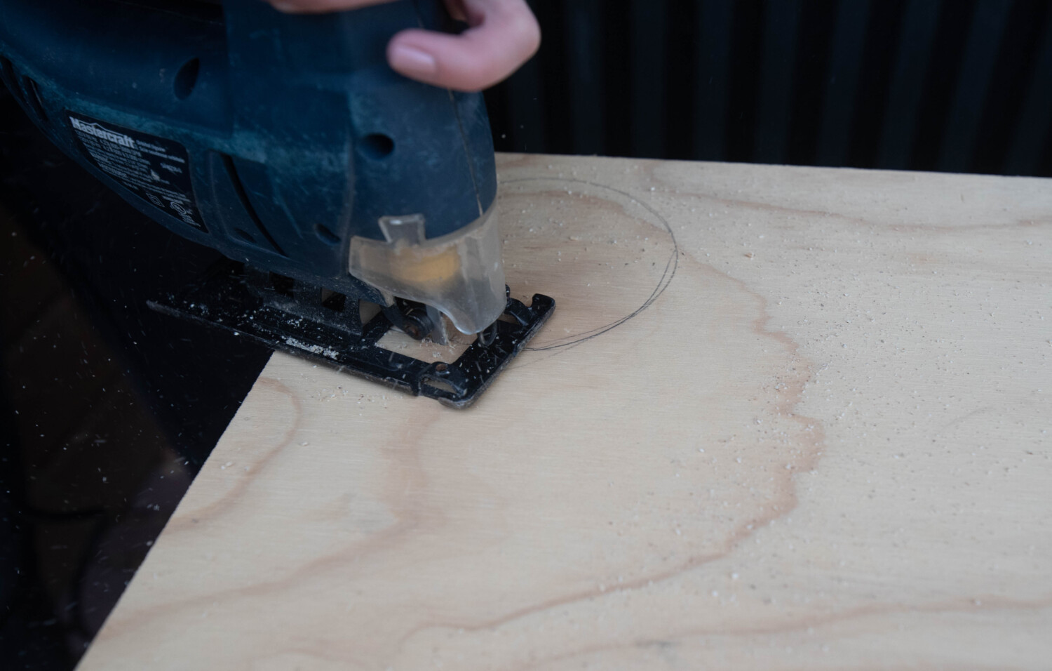 image shows jigsaw cutting plywood into a circle image in a blog post about choosing wood for diy projects