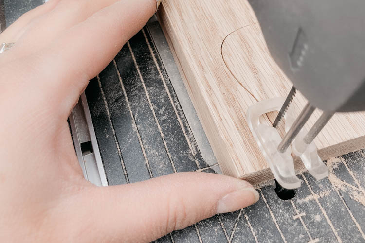 image shows hardwood being cut with a scroll saw