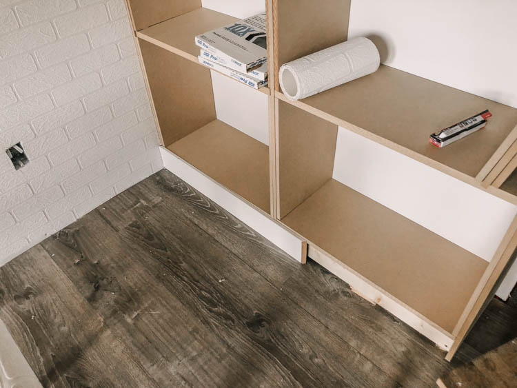 image of MDF panels cut to size and being assembled into DIY built in shelving.