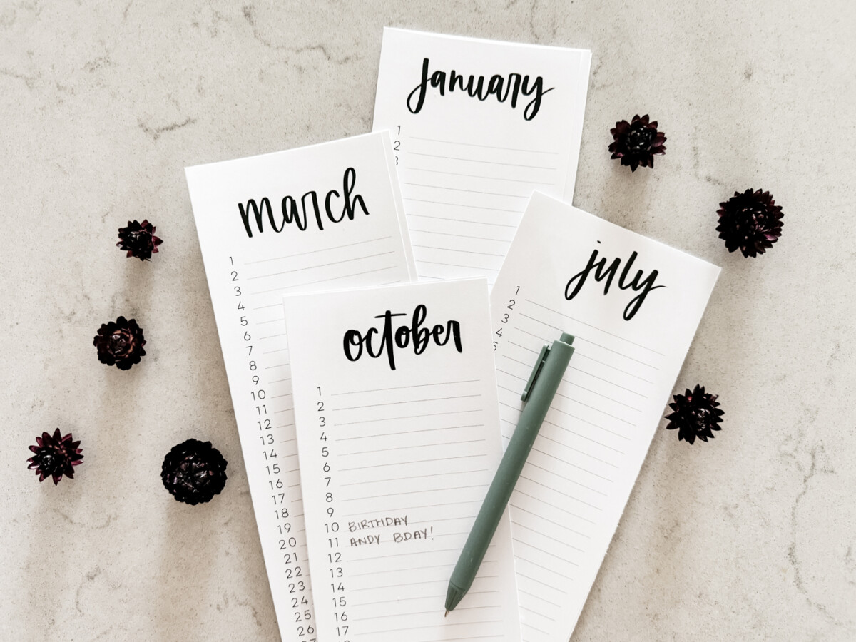 simple hand lettered list calendars free printable for 2025 both dated and perpetual, shown printed off on a marble countertop