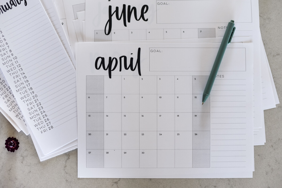 simple hand lettered collection of calendars including list calendars, perpetual calendars, monthly calendars, year at a glance calendar and large format calendars free printable for 2025, shown printed off on a marble countertop with green pen